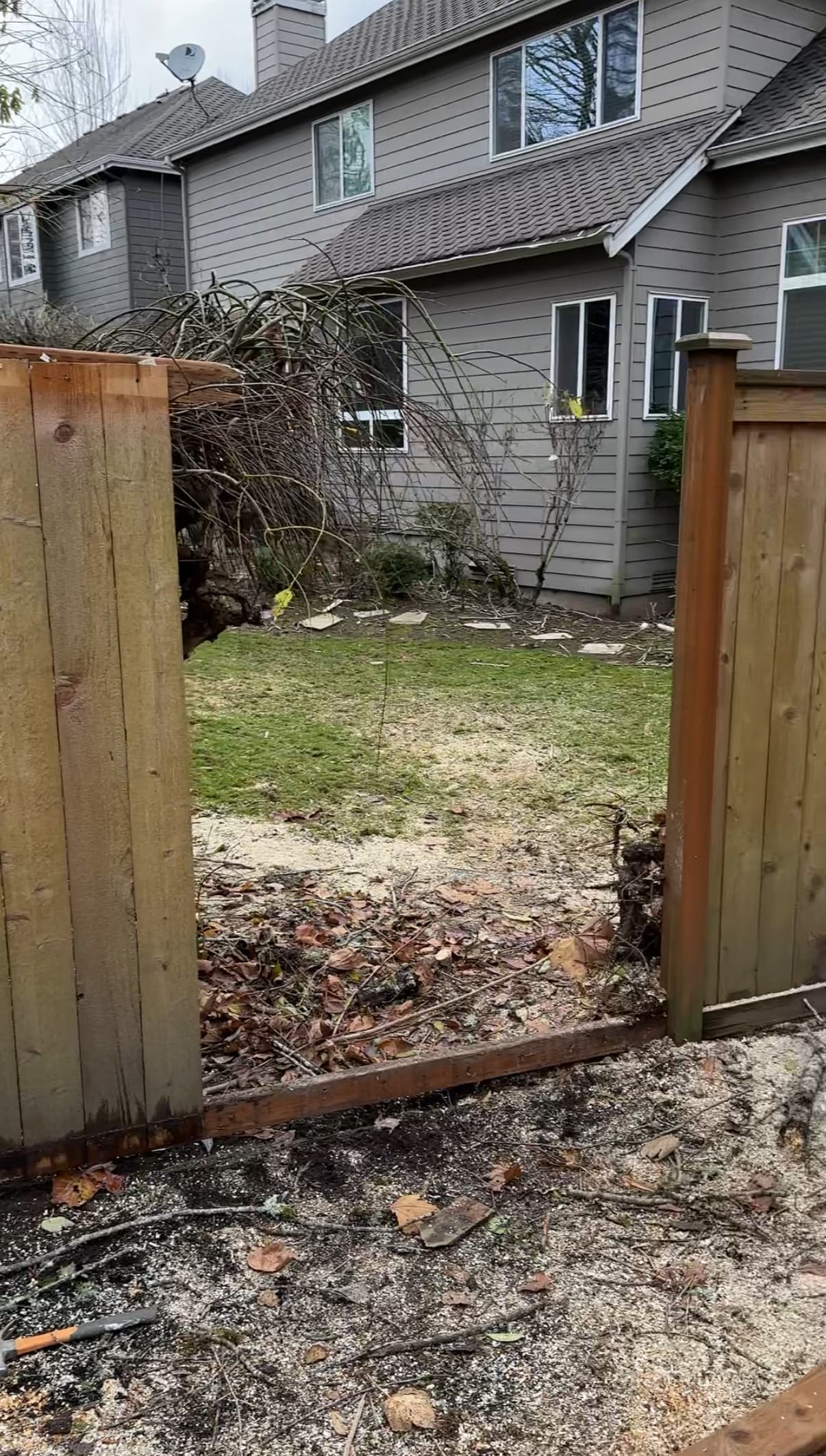 Before fence repair - damaged cedar fence needing professional repair